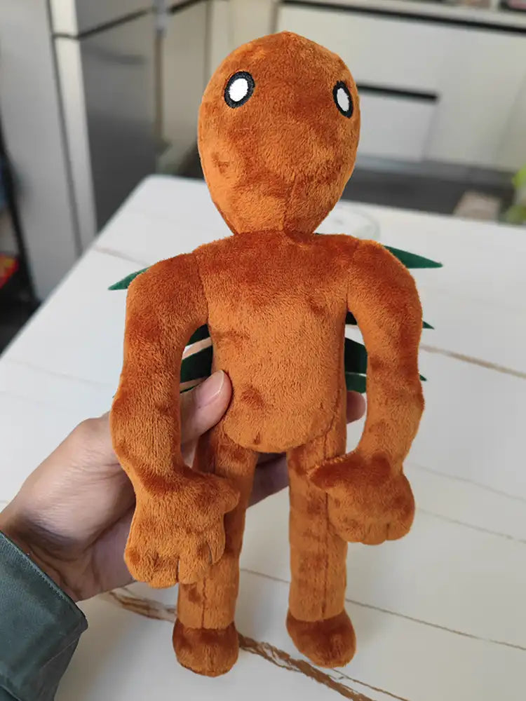 Hand holding bracken plush toy