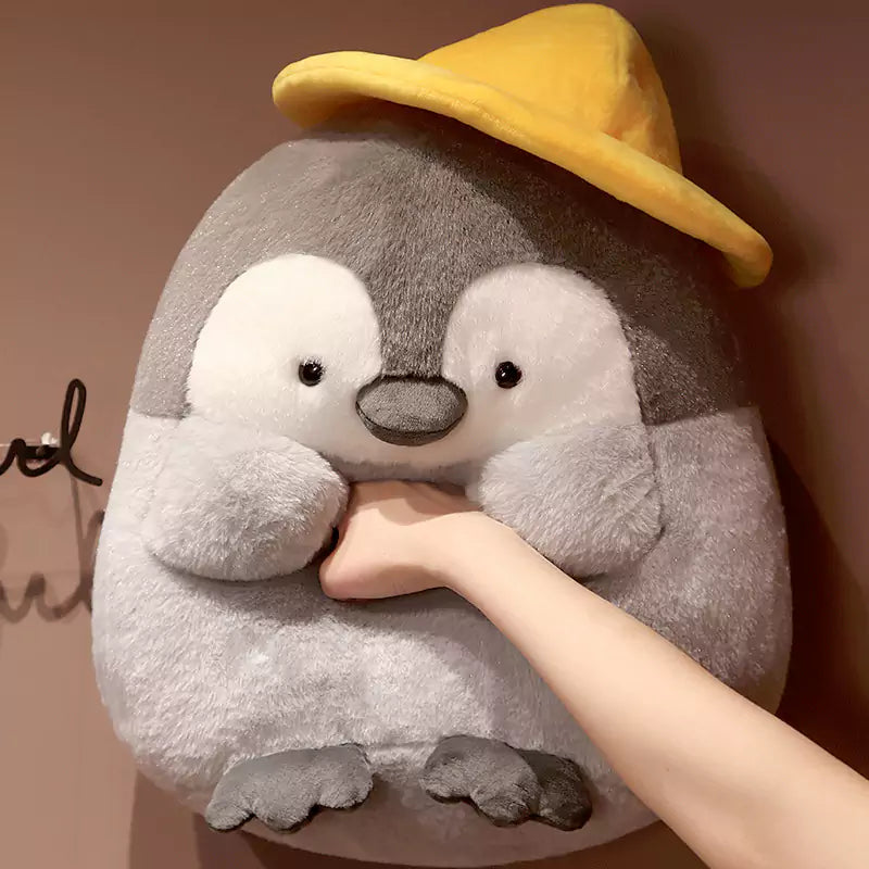 帽子をかぶったかわいいペンギンのぬいぐるみ メロンの種を持った子供たちへのクリスマスプレゼント Dookilive