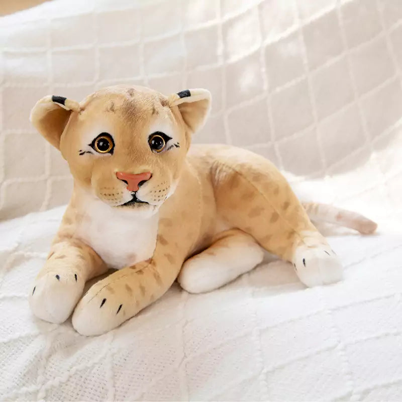 Plush stuffed lion ying on its side