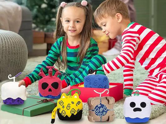 Boy and girl wearing striped clothes sitting on the ground playing with blox fruits plush