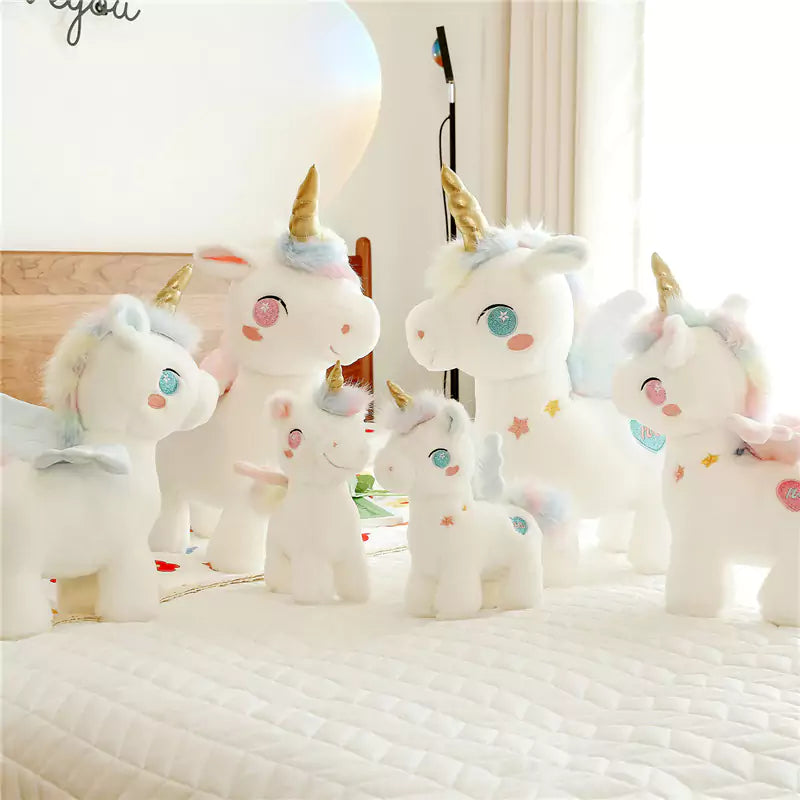 a group of unicorn stuffed animals