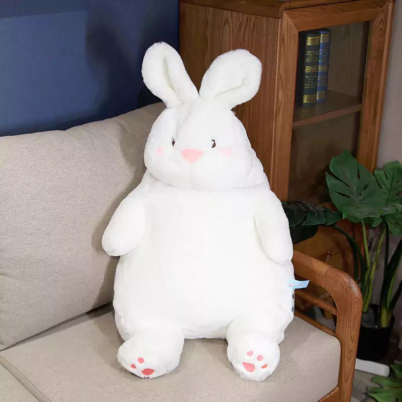 a white fat rabbit stuffed doll sat on the sofa