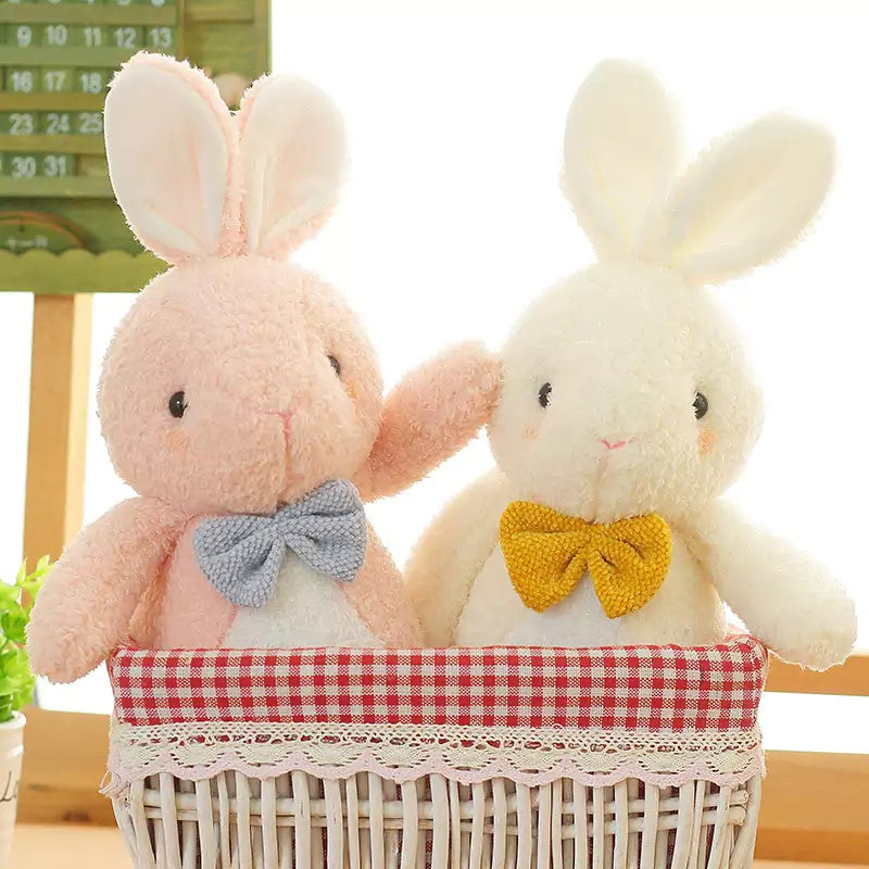 two stuffed bunnies with bows