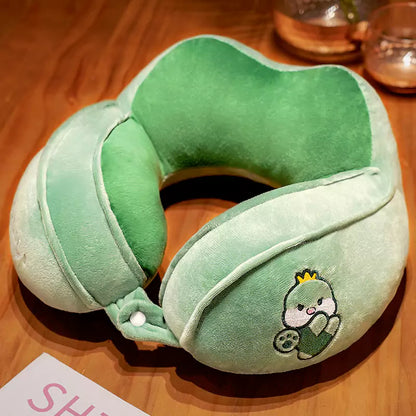 u shaped pillow with green dinosaur pattern